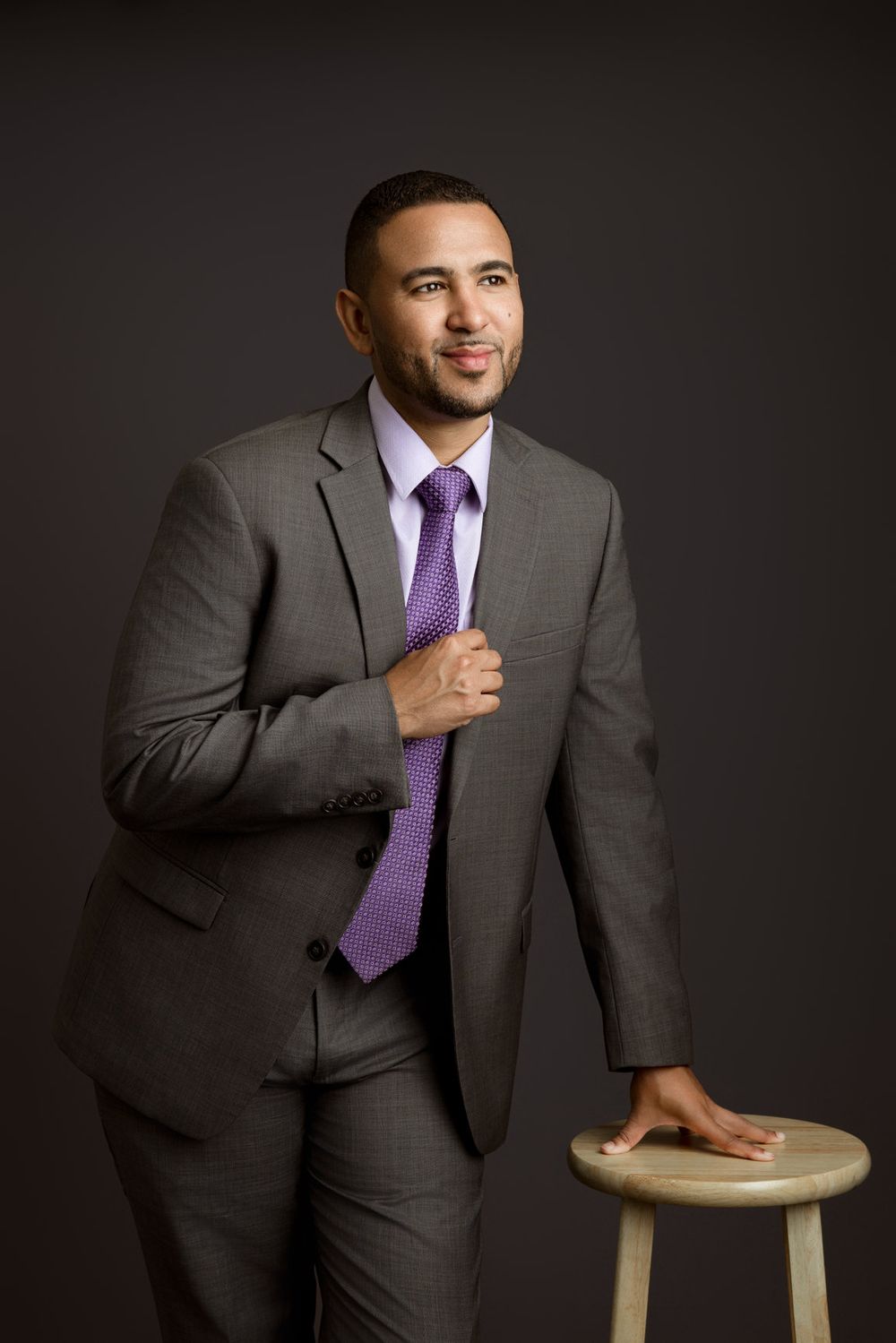 Professional Miami headshot of a man in a gray suit and purple tie by Batchen Parsons Photography.