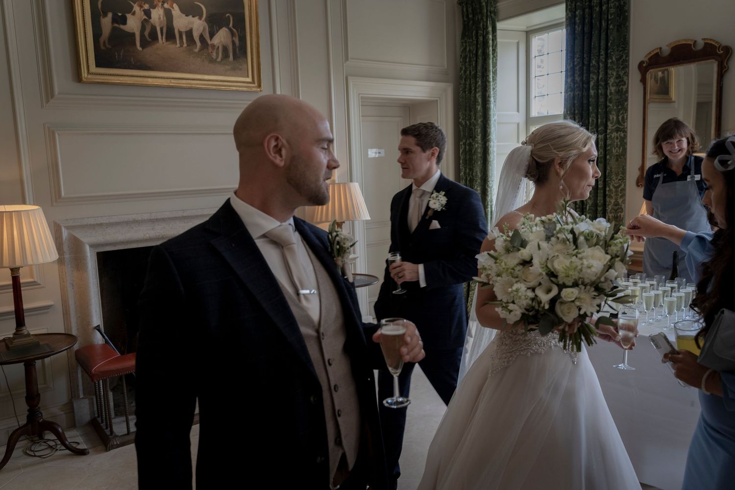 Elegant indoor wedding reception with formal attire and classic decor. Shilstone House Wedding. Devon Wedding Photography.