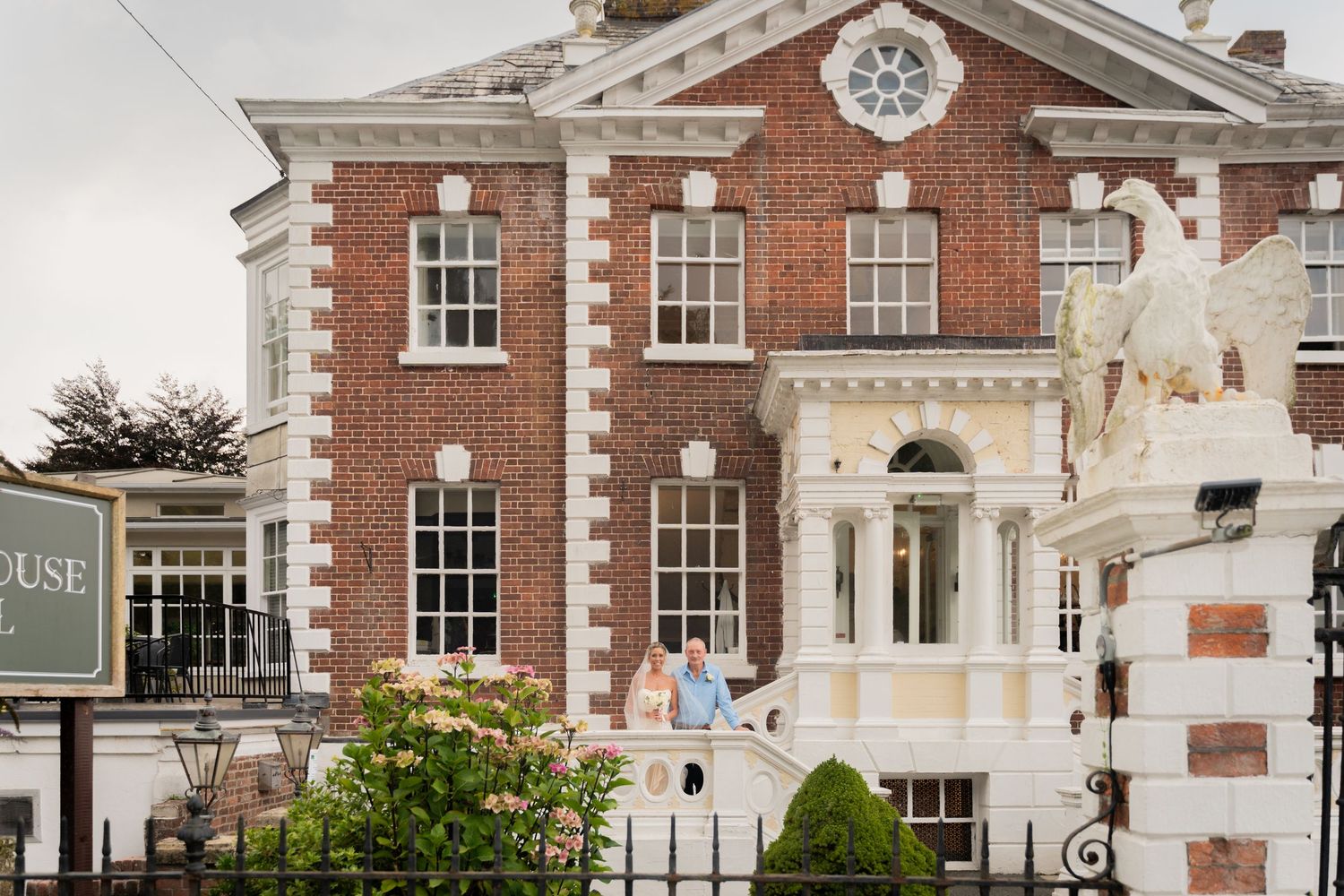 Elegant red brick Georgian style building with white trim and classical architectural details in an upscale neighborhood.