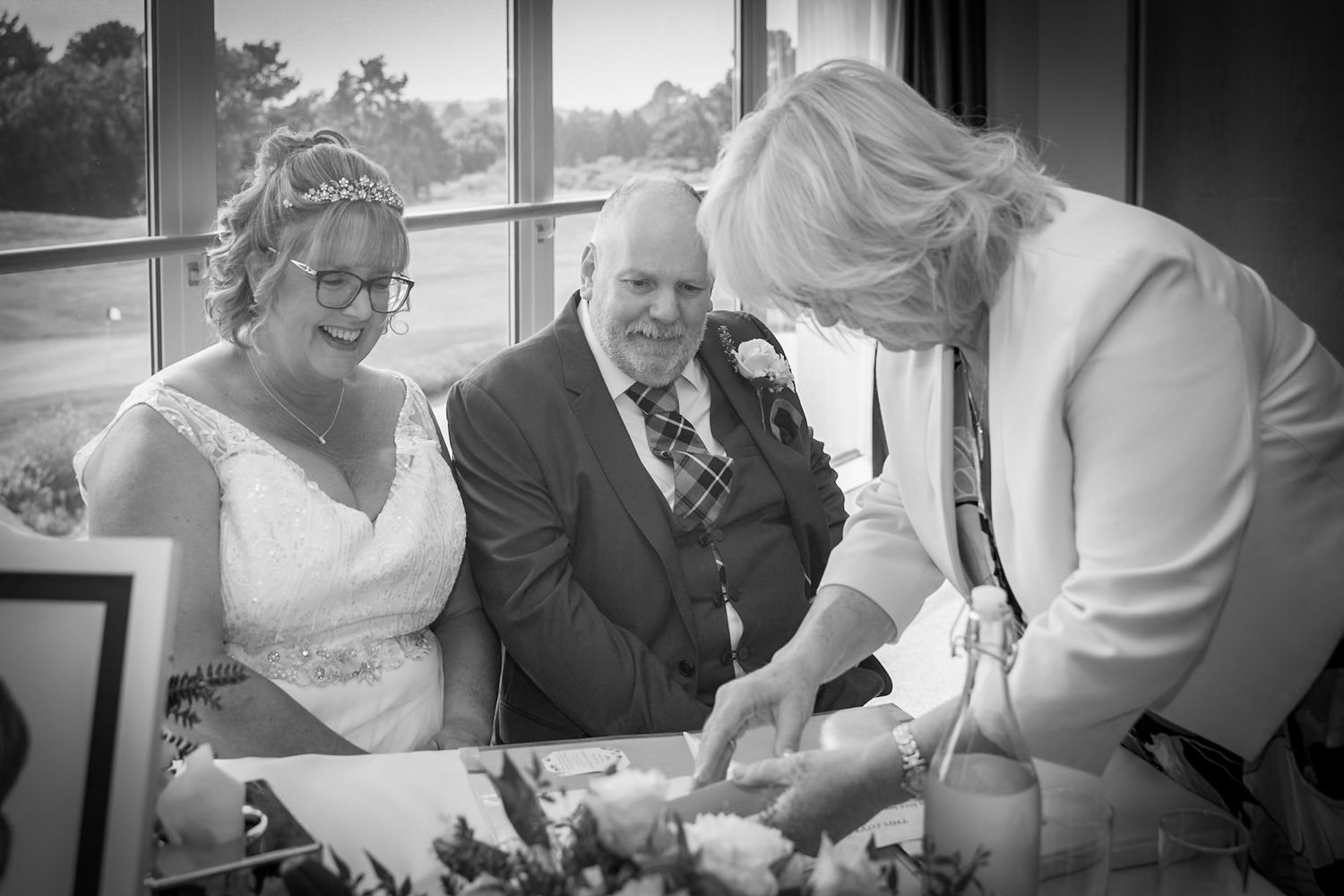 Black and white candid shots of wedding reception moments and guest interactions.