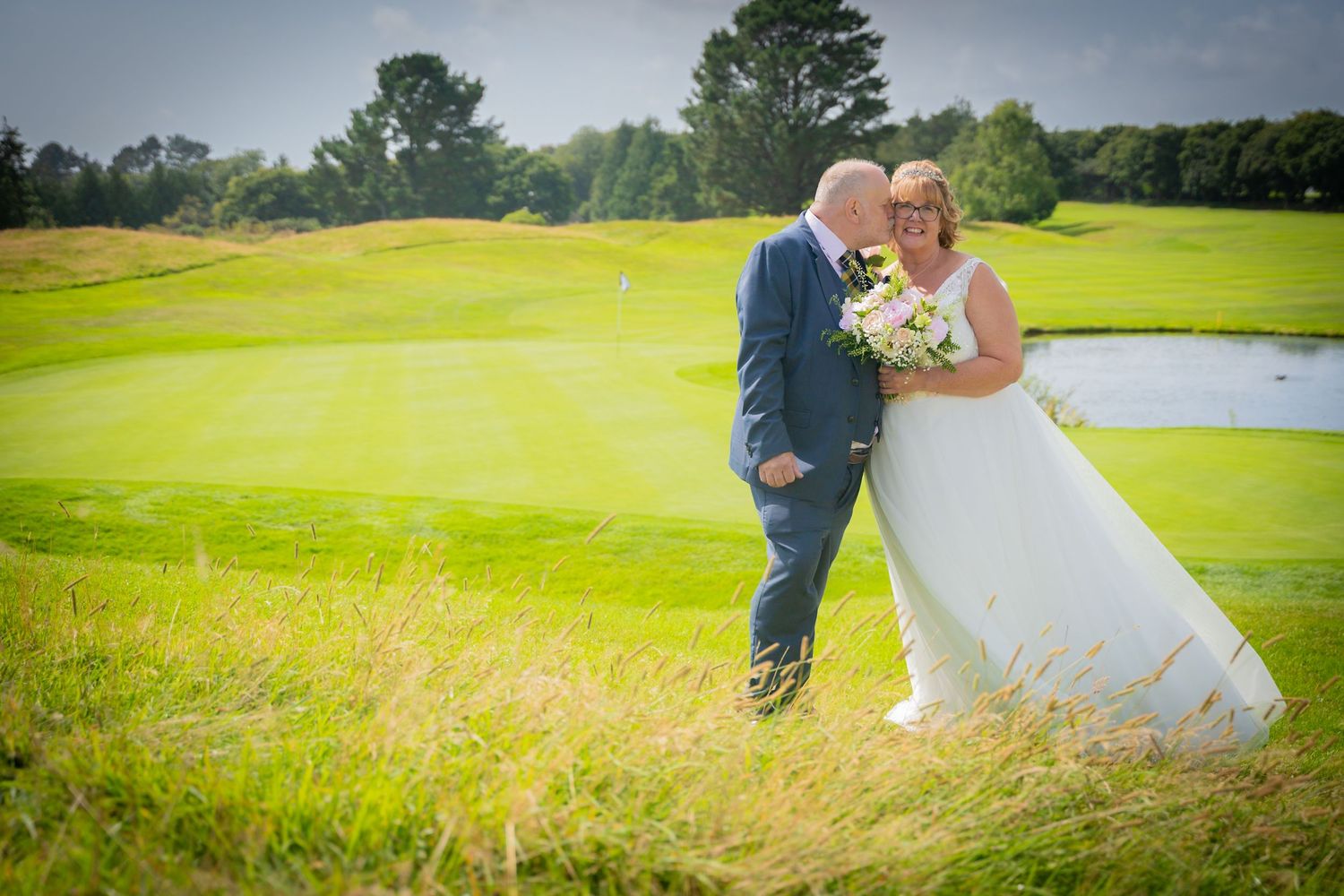 Newlywed couple shares romantic moments on a lush green golf course with multiple scenic photo opportunities.