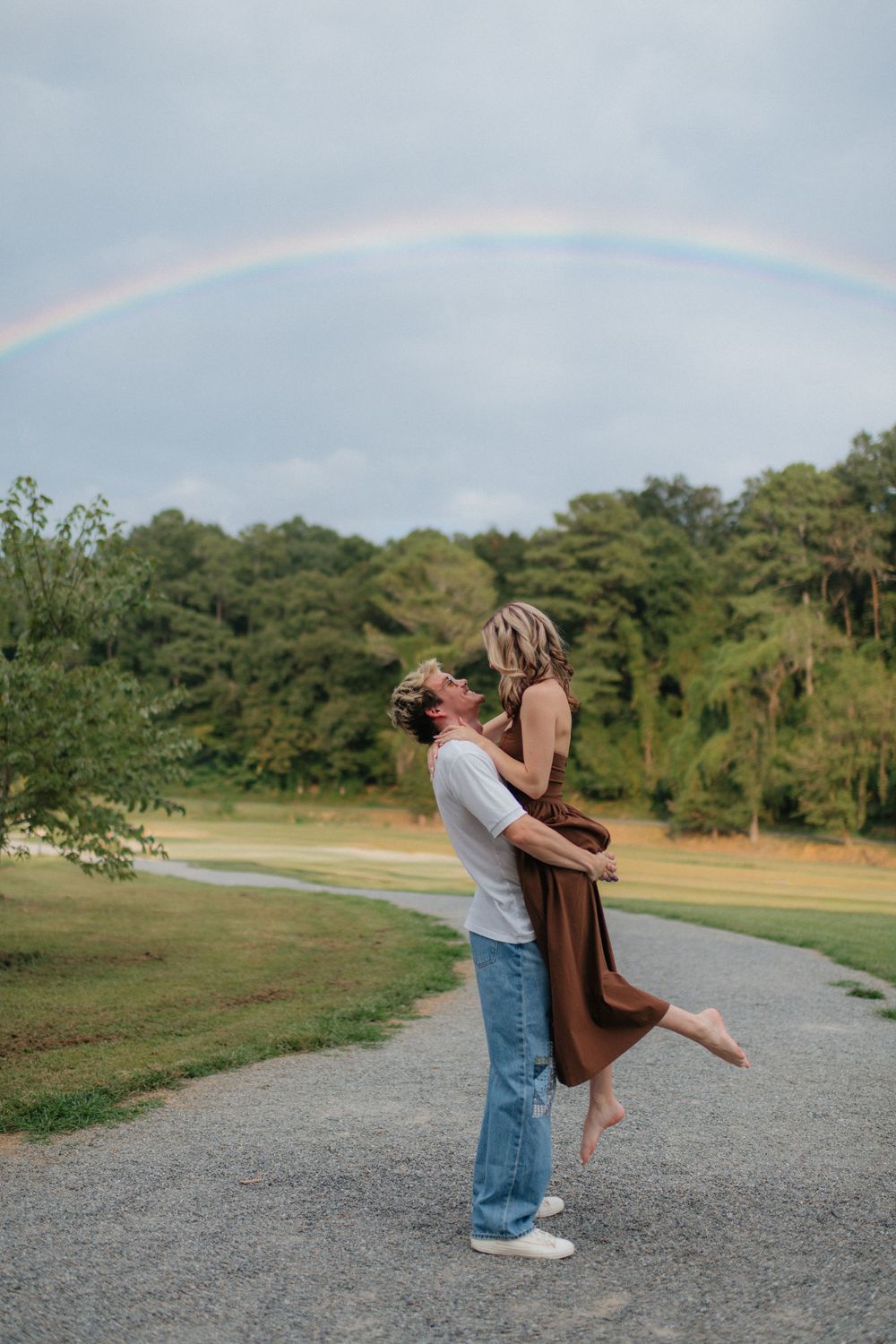Couple at Harrison Park near downtown Ellijay, Georgia. Rainbow in background