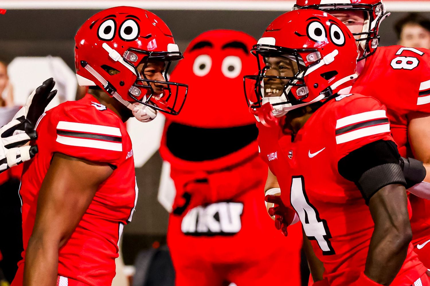 Western Kentucky's Running Back George Heart (9) and Wide Receiver Michael Mathison (4) celebrate a touchdown as Big Red watches.