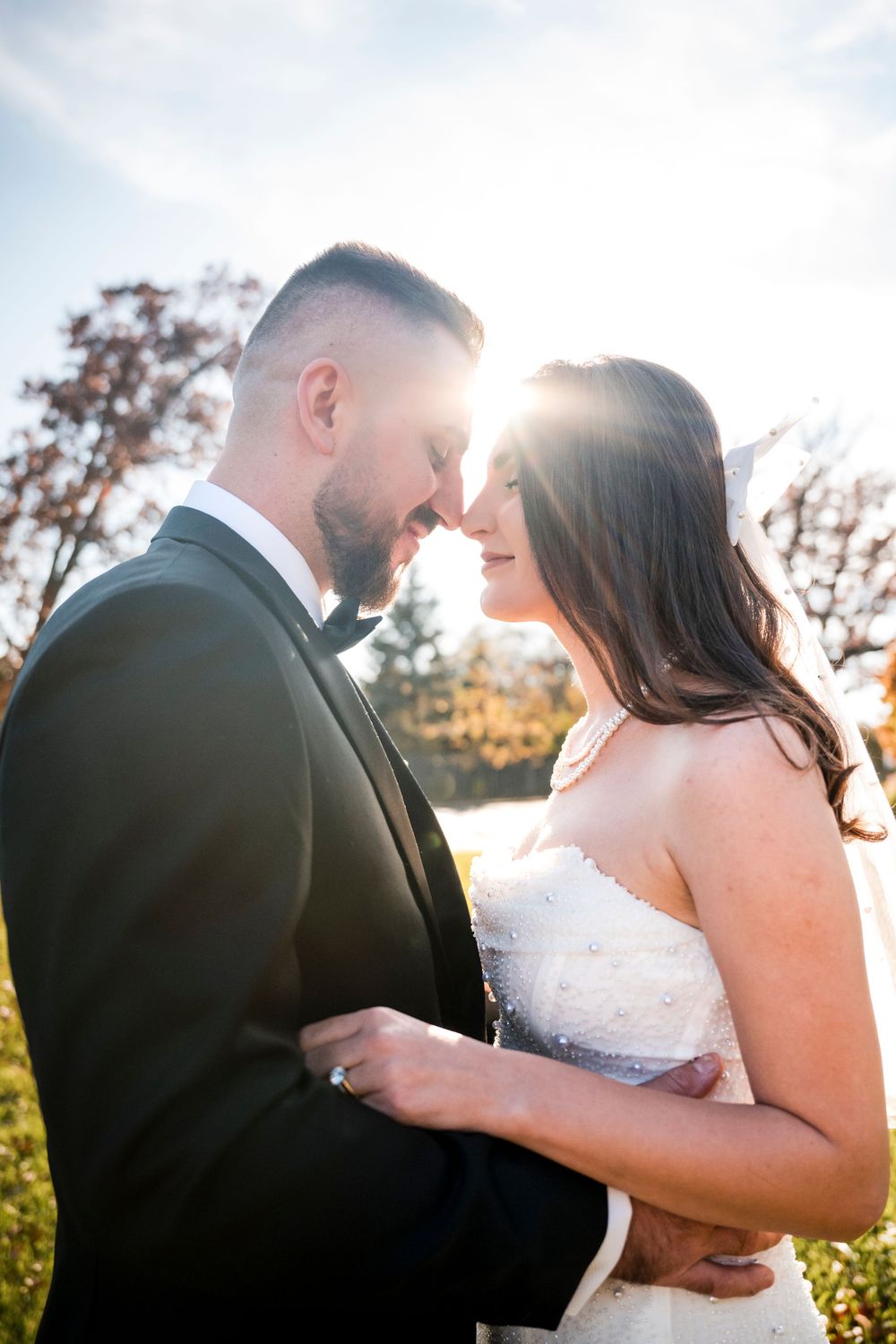 A romantic wedding couple embraces during golden hour sunset, captured in a series of intimate close-up shots.