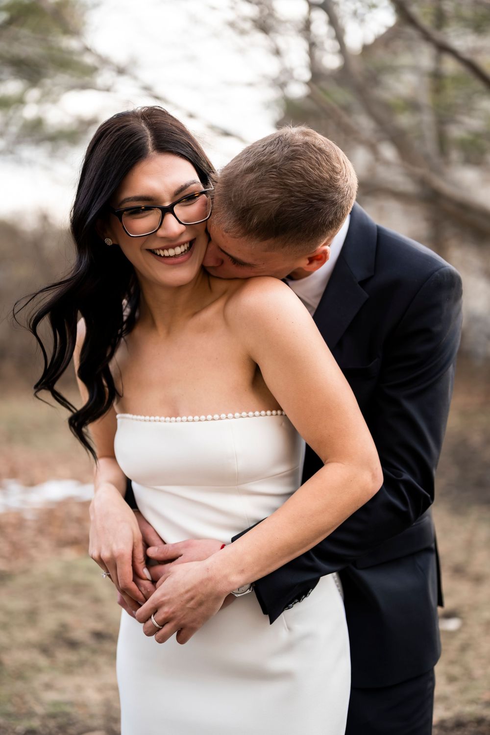 A series of candid wedding photos showing intimate moments between a couple embracing and laughing together outdoors.