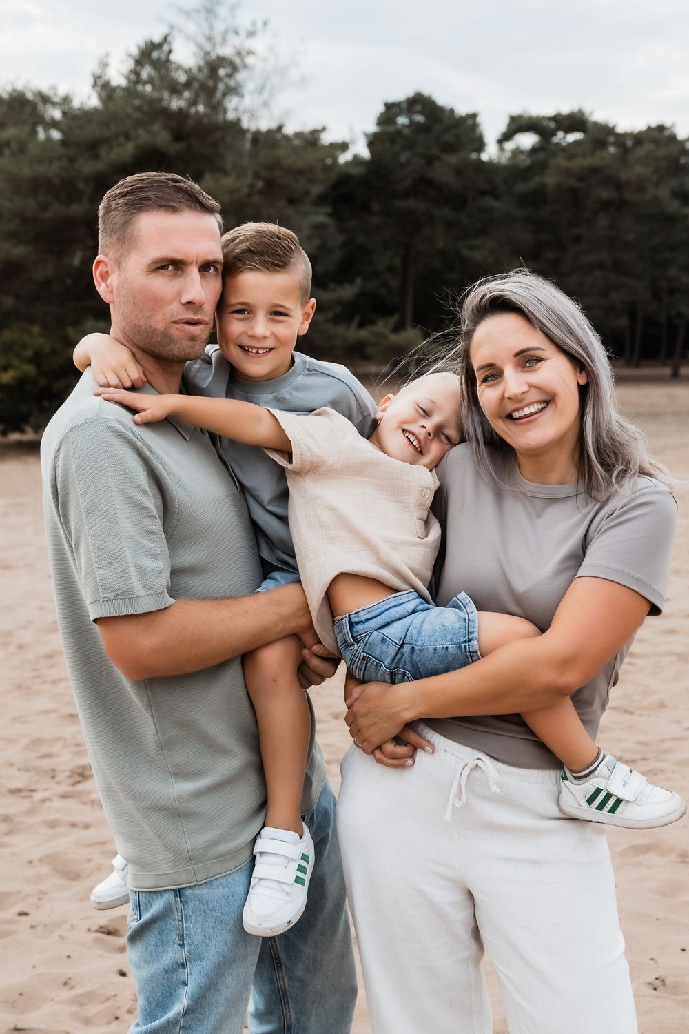 A series of candid family photos showing joyful moments and embraces on a sandy beach at sunset.