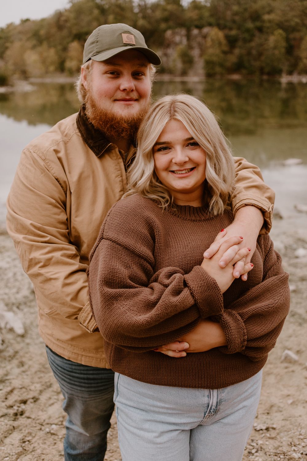 Romantic candid shots of a couple embracing outdoors in autumn wearing brown and tan clothing.