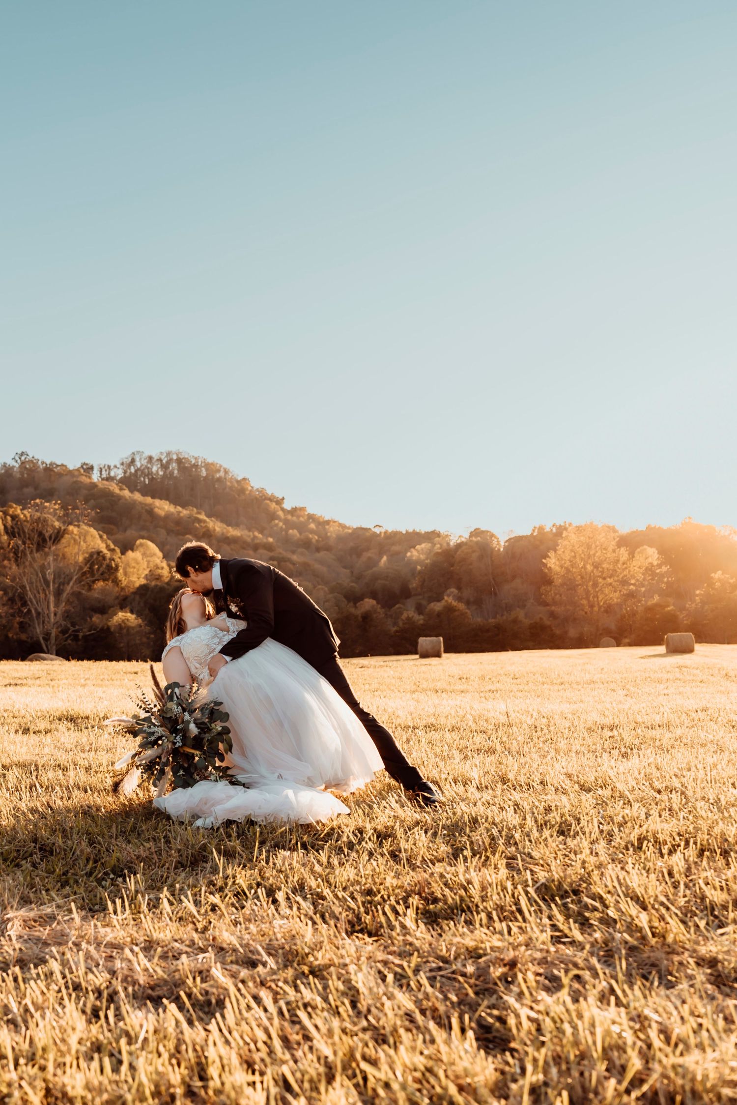 Wedding photo in field with mountain views