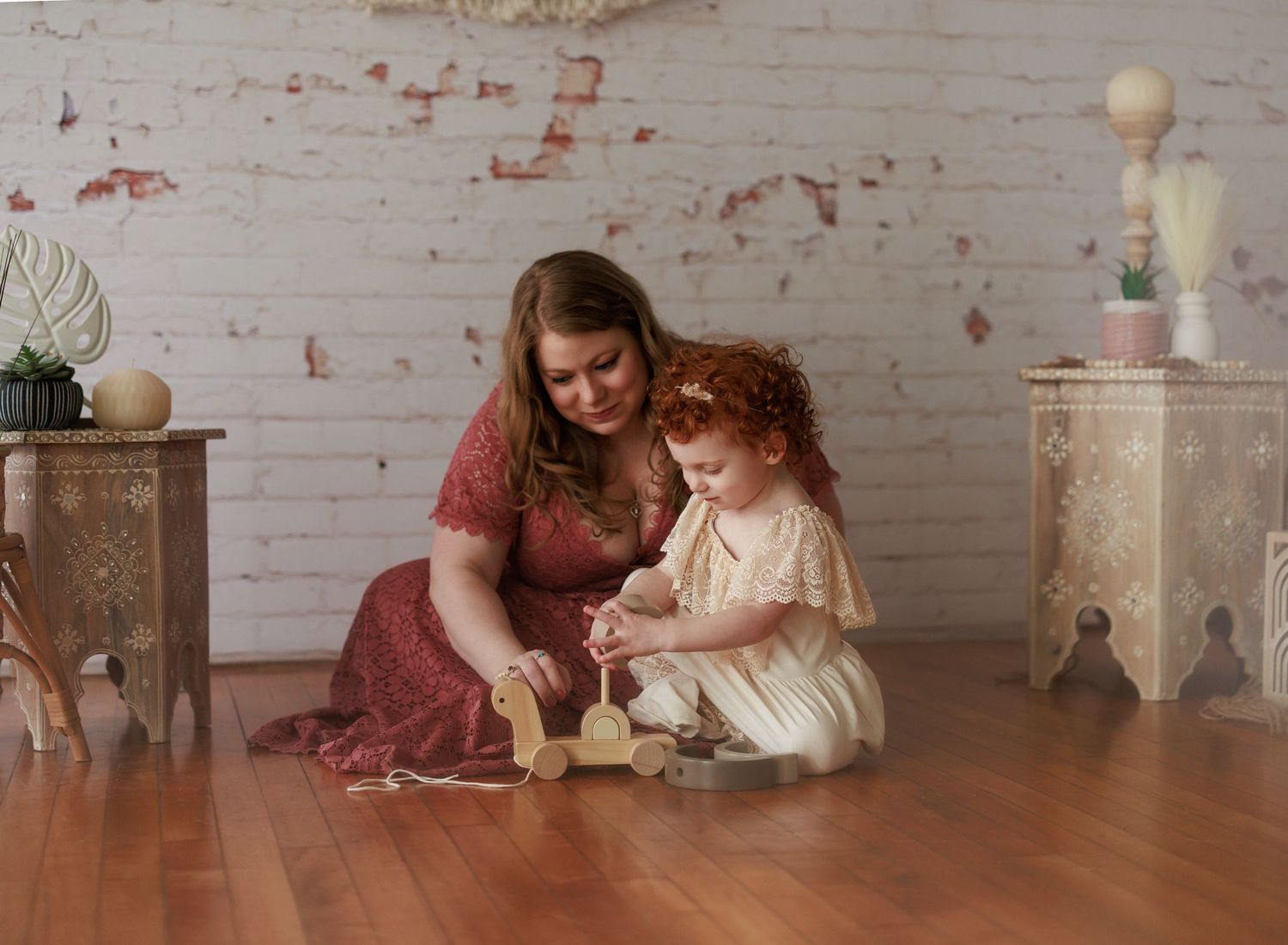 A series of five connected images showing someone sitting on a wooden floor with decorative elements in the background.