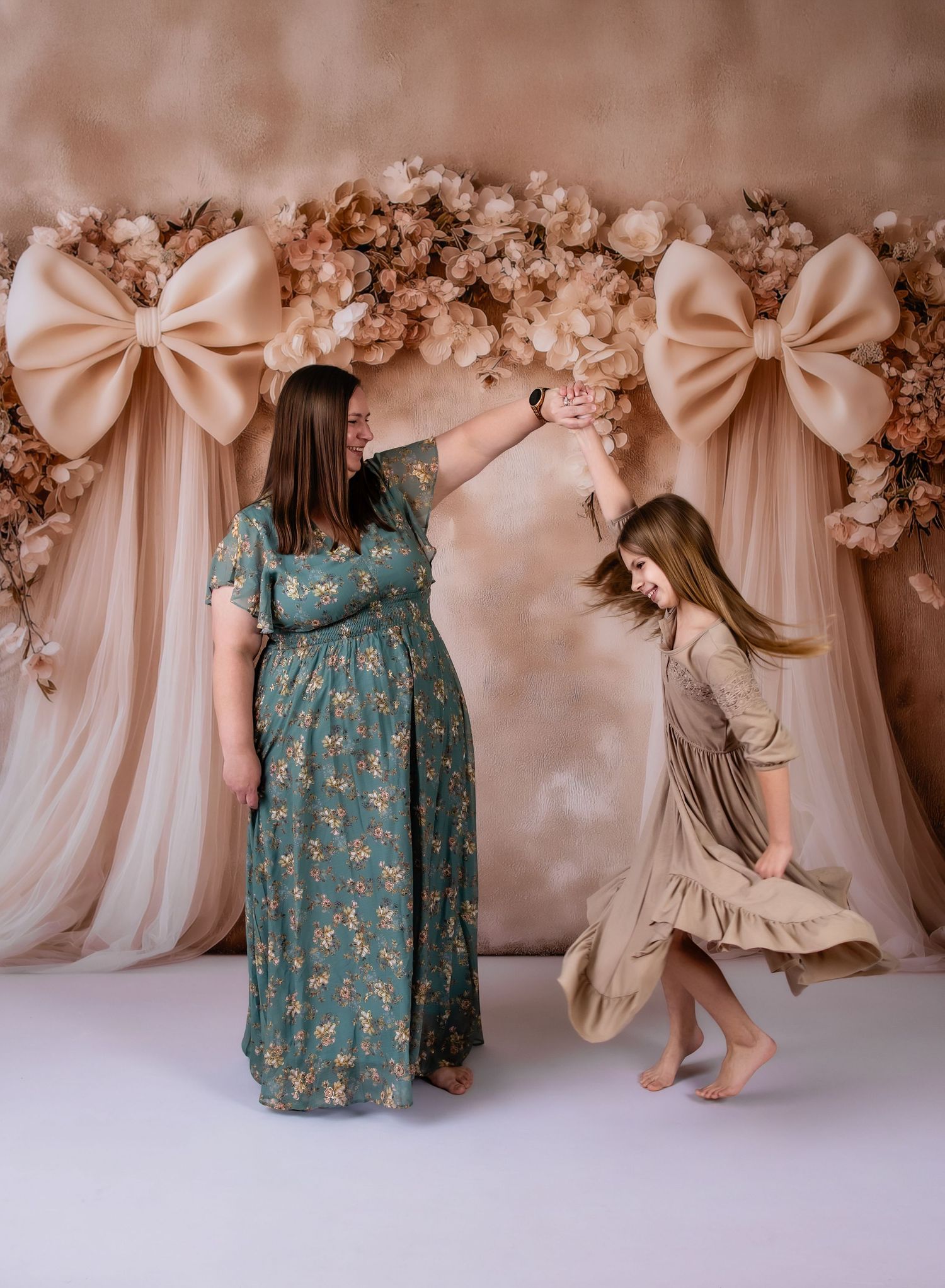 Vintage-inspired children's dresses in blue floral and beige displayed against a romantic floral backdrop with soft lighting.