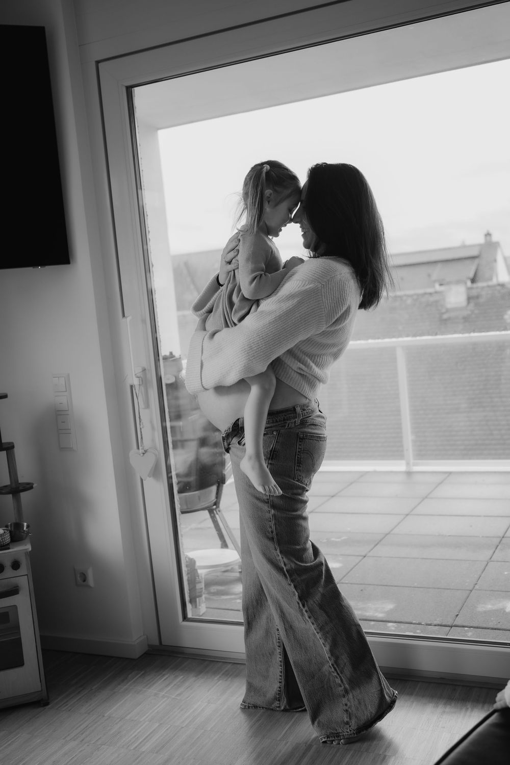 Black and white sequence showing a couple dancing together in front of a window, creating a romantic silhouette effect.