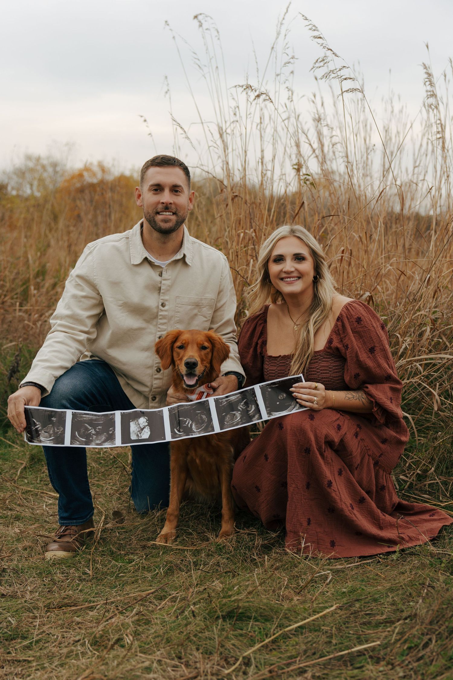 Intimate maternity session in a wooded area with natural lighting.