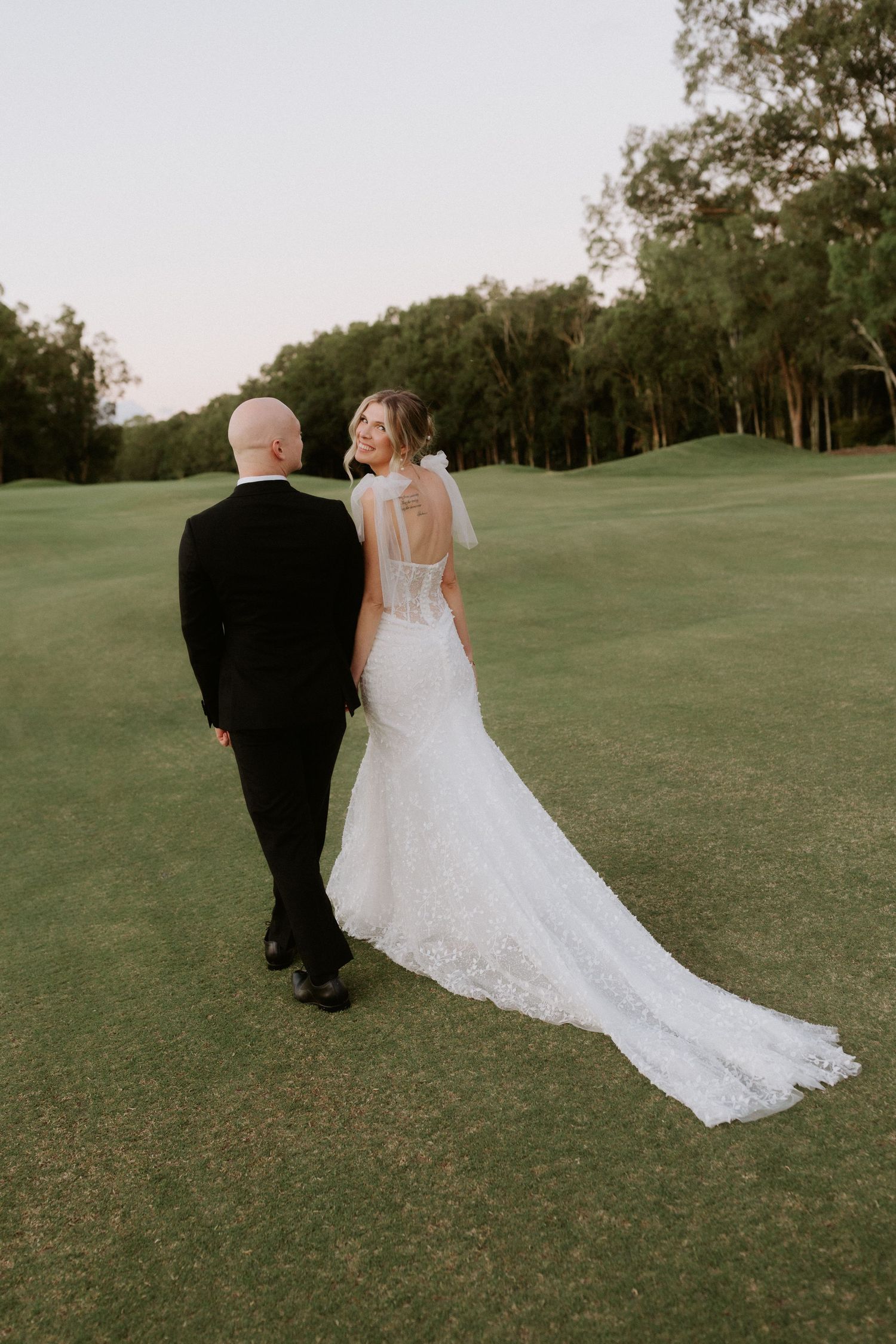 Romantic wedding couple sharing intimate moments in soft lighting.