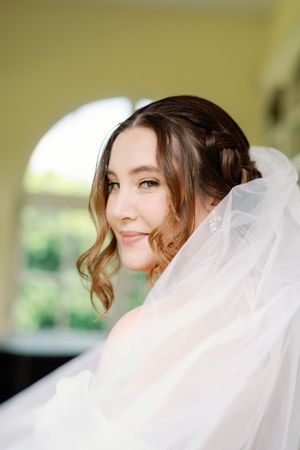A bridal portrait series shows flowing white veil and delicate makeup details in natural light.
