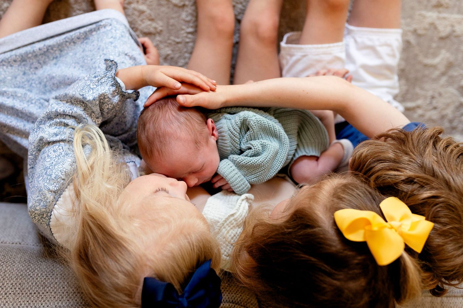 Newborn family cuddling together during a lifestyle photography session in Davidson, NC