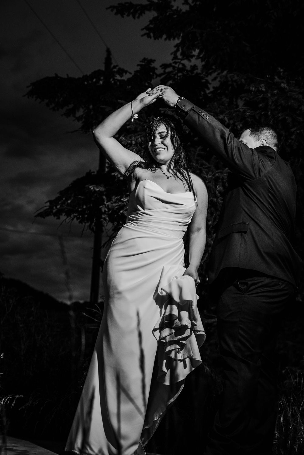 Bride being spun by groom in black and white shot