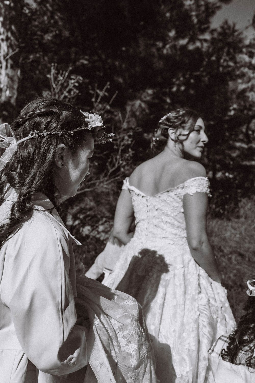 Flower girl carrying brides dress hiking to their adventure elopement location at Minnewaska State Park