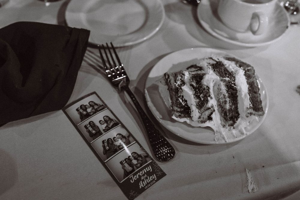 Detail lived in shot of polaroids and wedding cake at West Point wedding