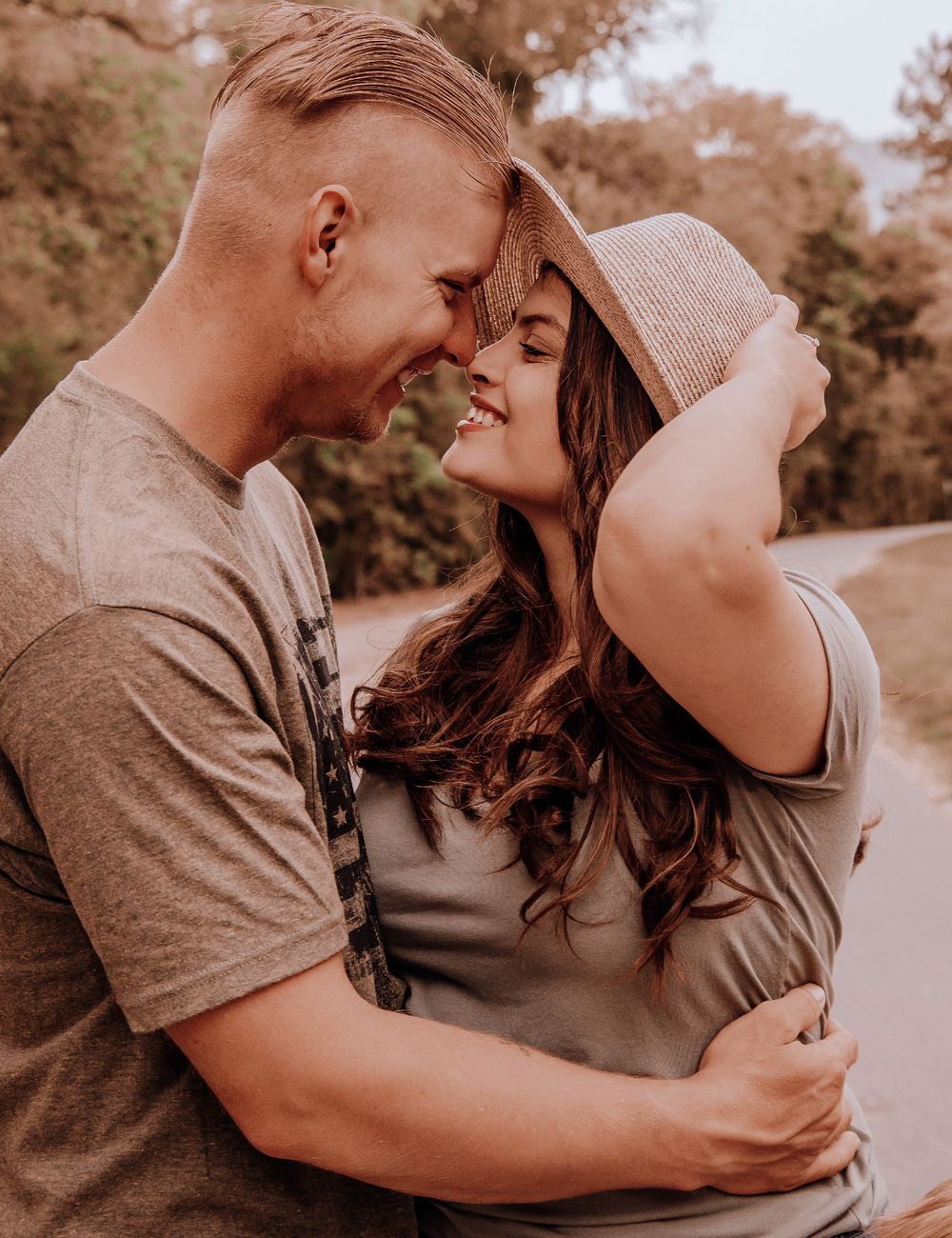 A romantic couple embraces and shares intimate moments in a series of sepia-toned photographs.