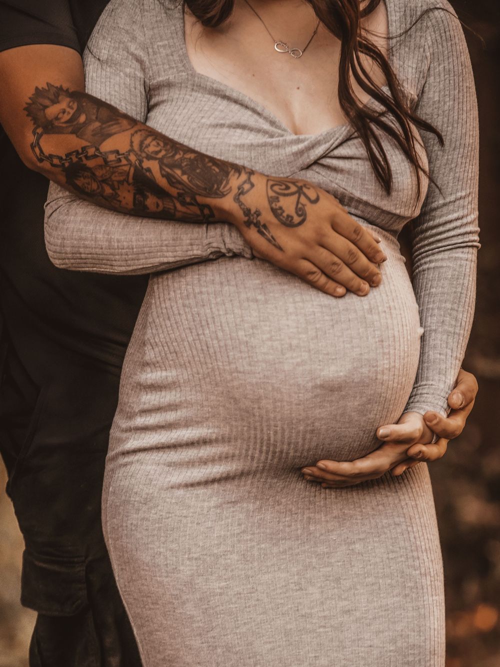 Close-up series of a pregnant woman in a gray ribbed dress showing her baby bump from different angles.