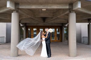 Minimalist concrete wedding venue with pillars and covered walkway.