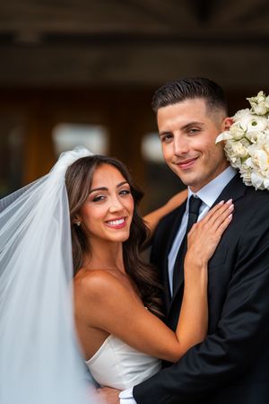 Elegant wedding couple sharing romantic moments in modern architectural setting.