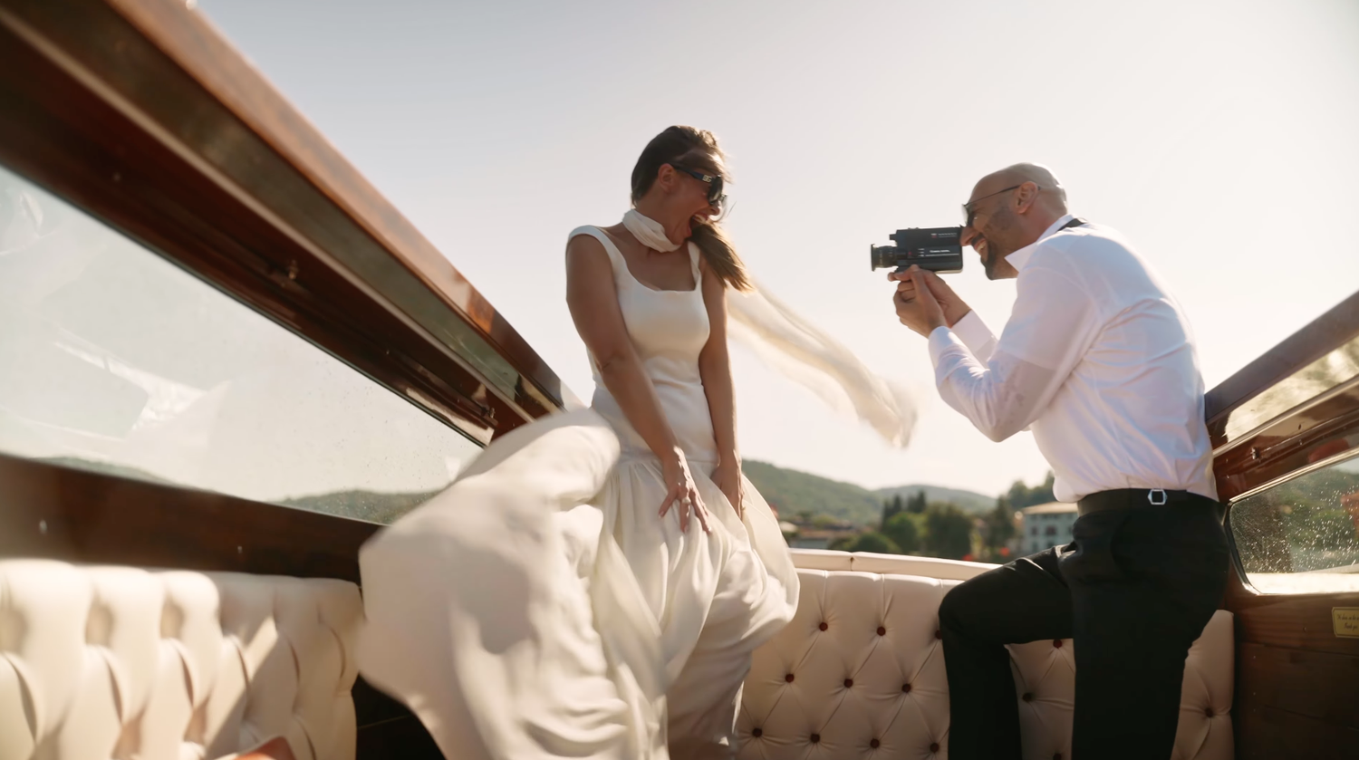 Bride and groom sharing a tender kiss in a natural setting, celebrating their love.