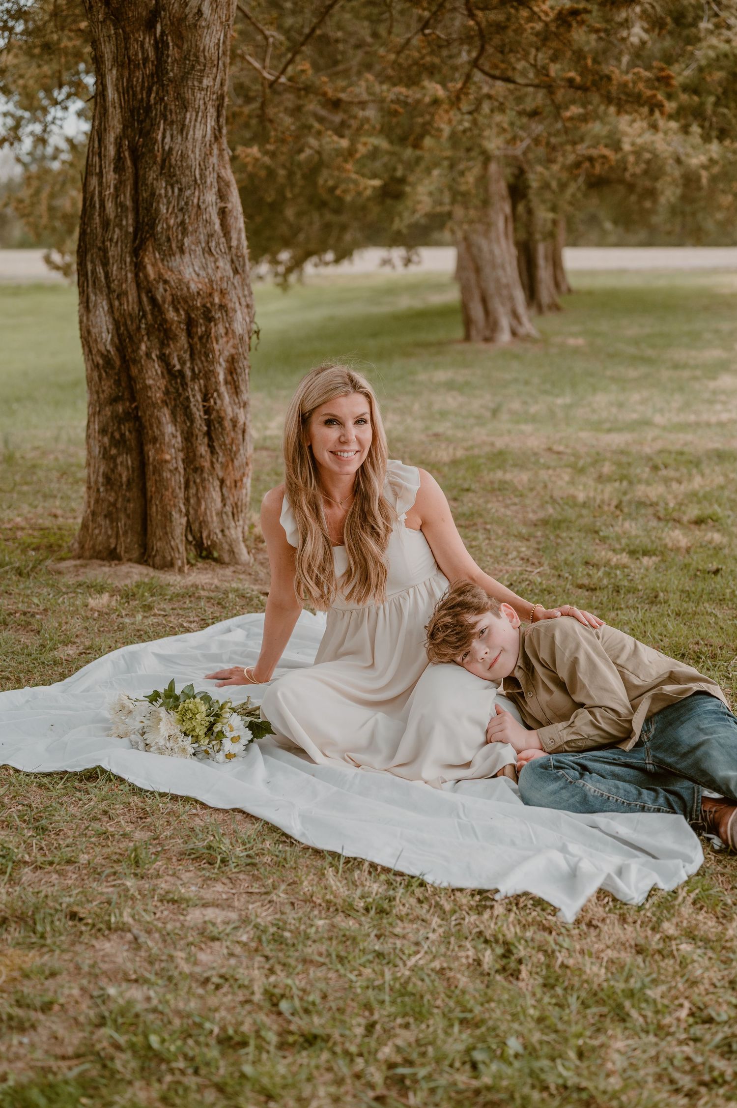 A playful moment outdoors as a small child is held upside down while laughing with joy during playtime. photo by Samantha Campbell imagery