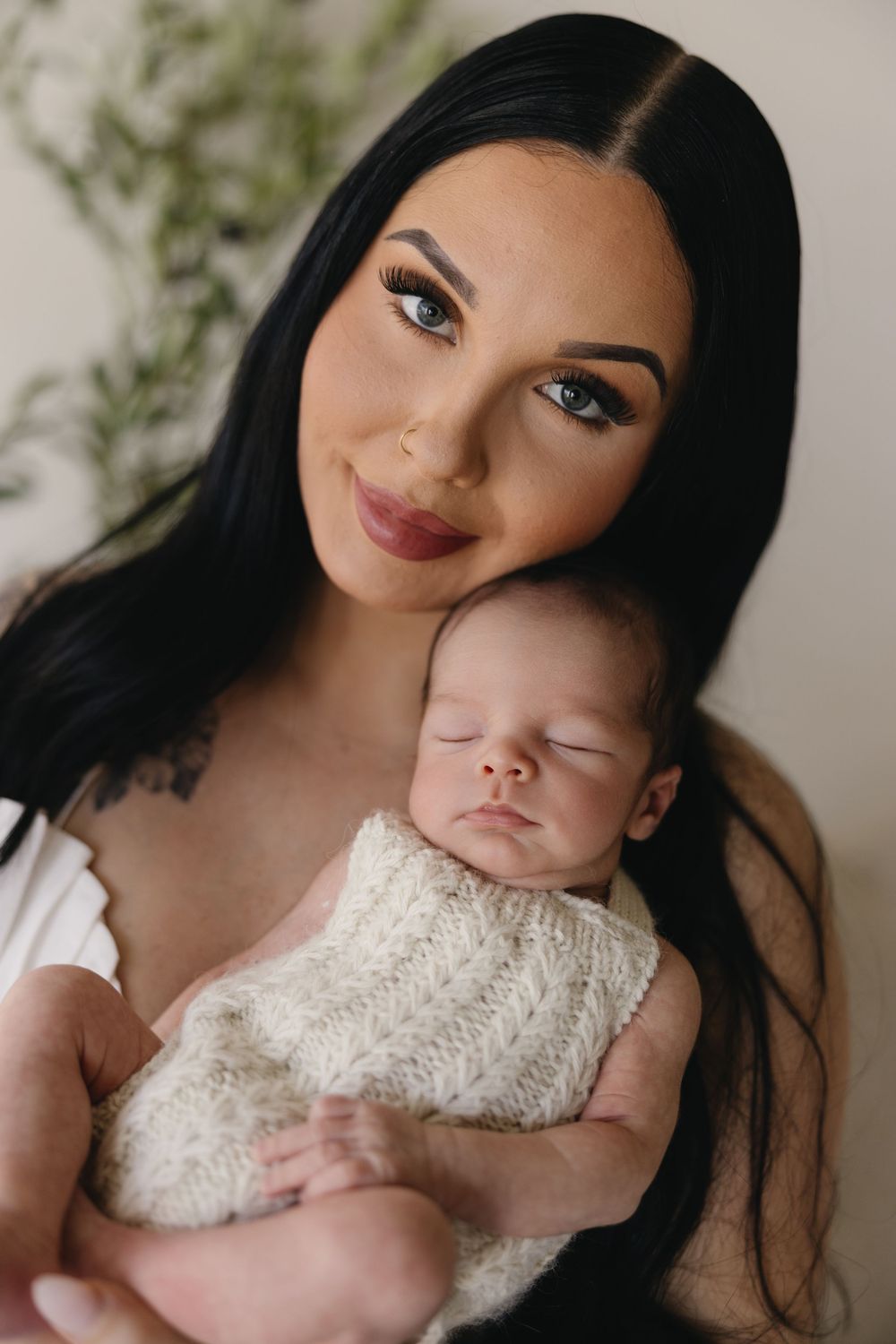 A series of intimate portraits showing tender moments between a woman and a newborn baby in soft lighting.