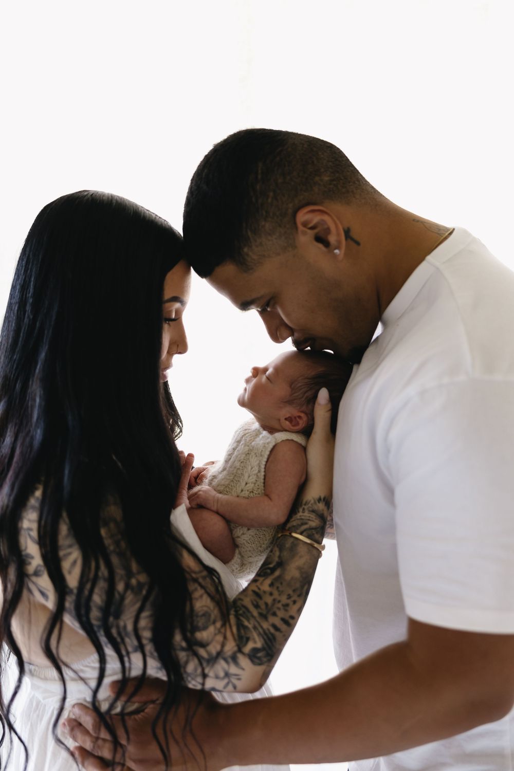 A sequence of loving family moments captured in profile against a white background showing parents with their newborn.