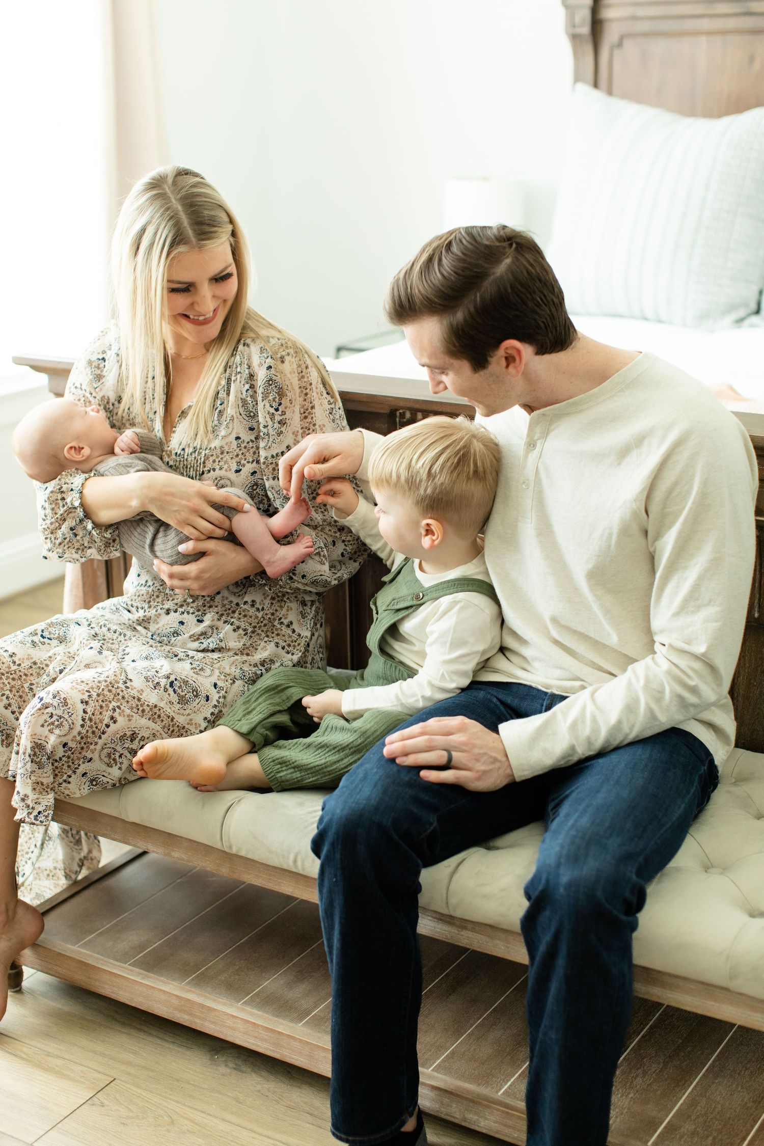 A family moment on a couch with a baby and toddler.
