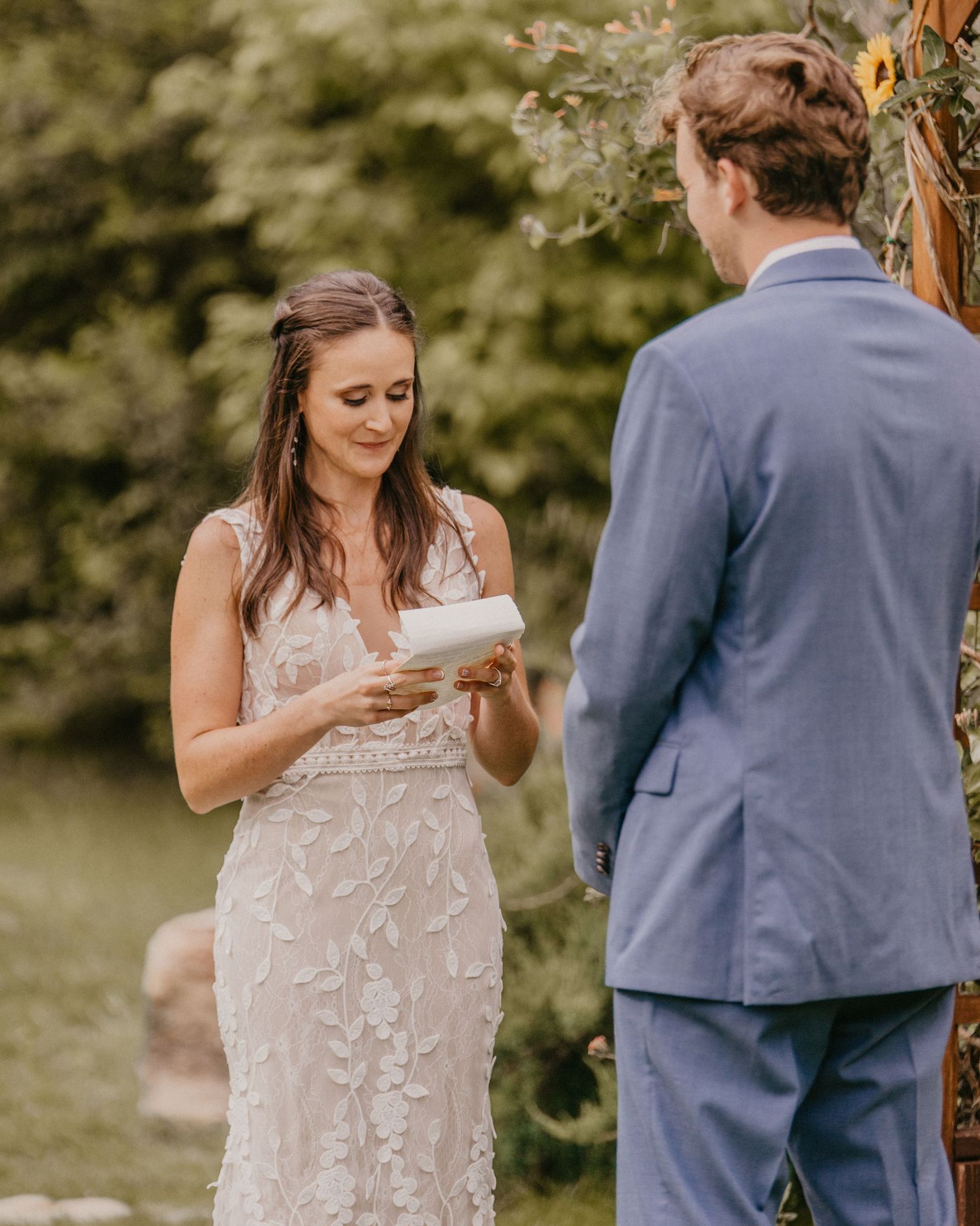 At the altar, exchange of vows during an outdoor garden wedding ceremony.