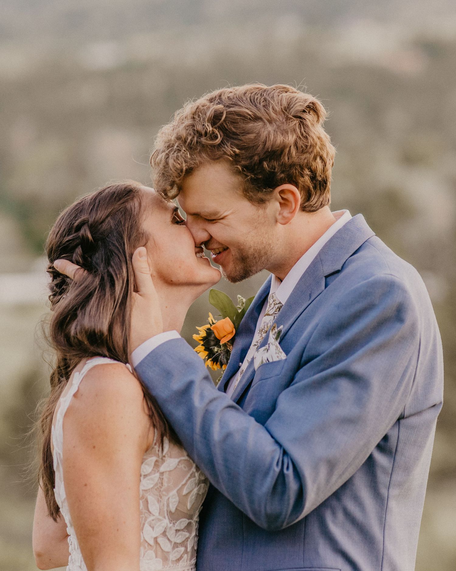 Intimate moment shared during a mountain wedding with scenic natural backdrop.