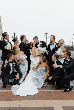 Fun wedding party photos showing group poses on brick patio in formal attire.