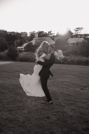 A dramatic wedding dance dip pose captured in black and white photography.