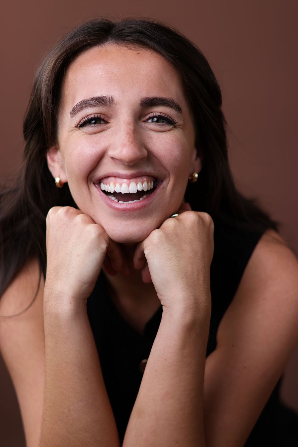 A sequence of joyful expressions showing genuine laughter and happiness against a dark background.