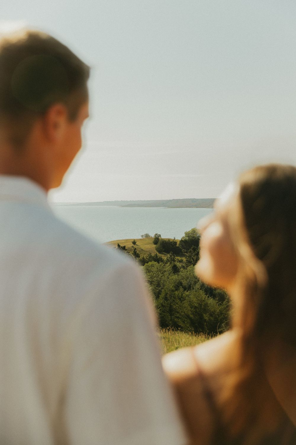 A soft focus portrait against rolling hills and summer sky.