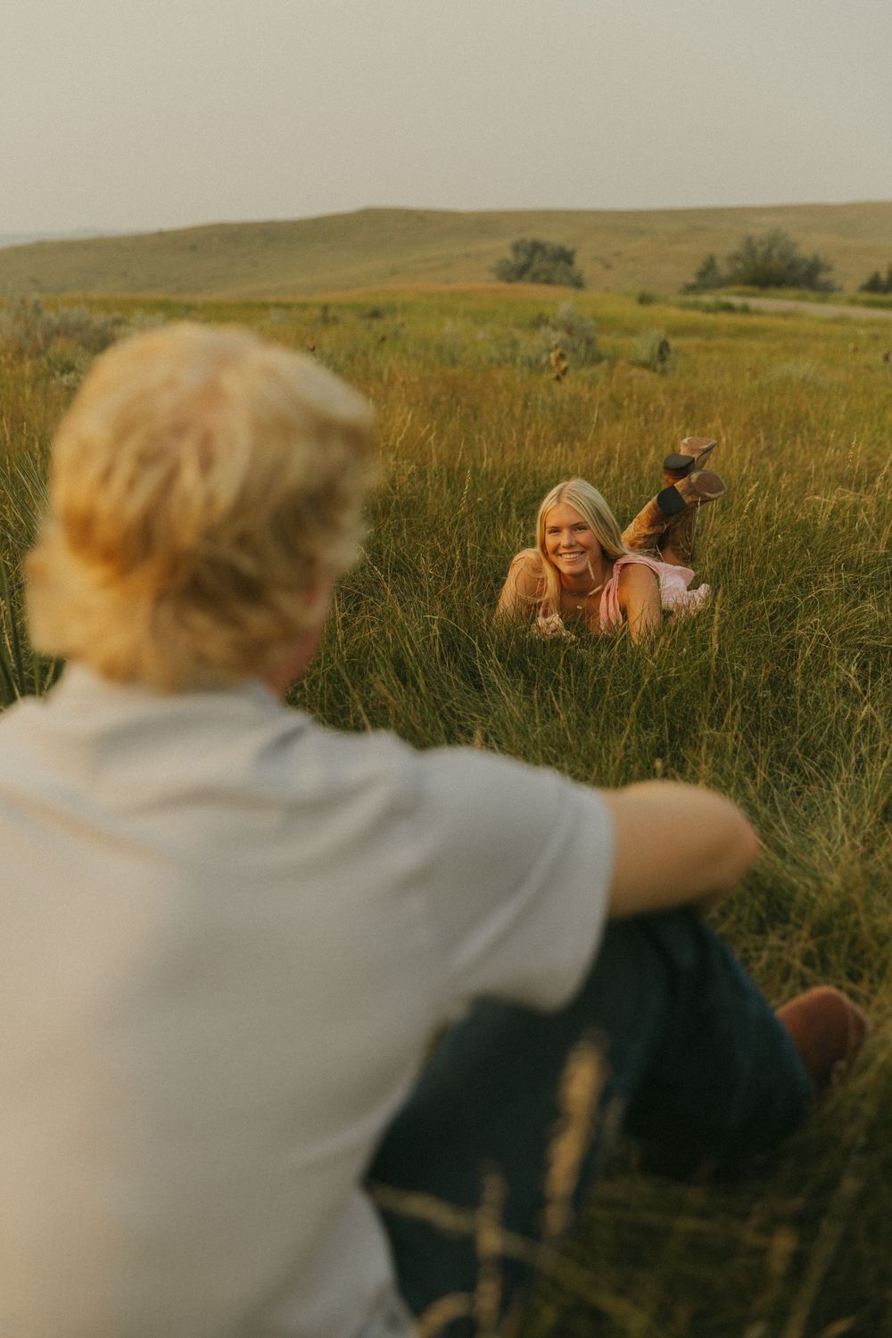 Candid moments captured in a sun-drenched prairie field.