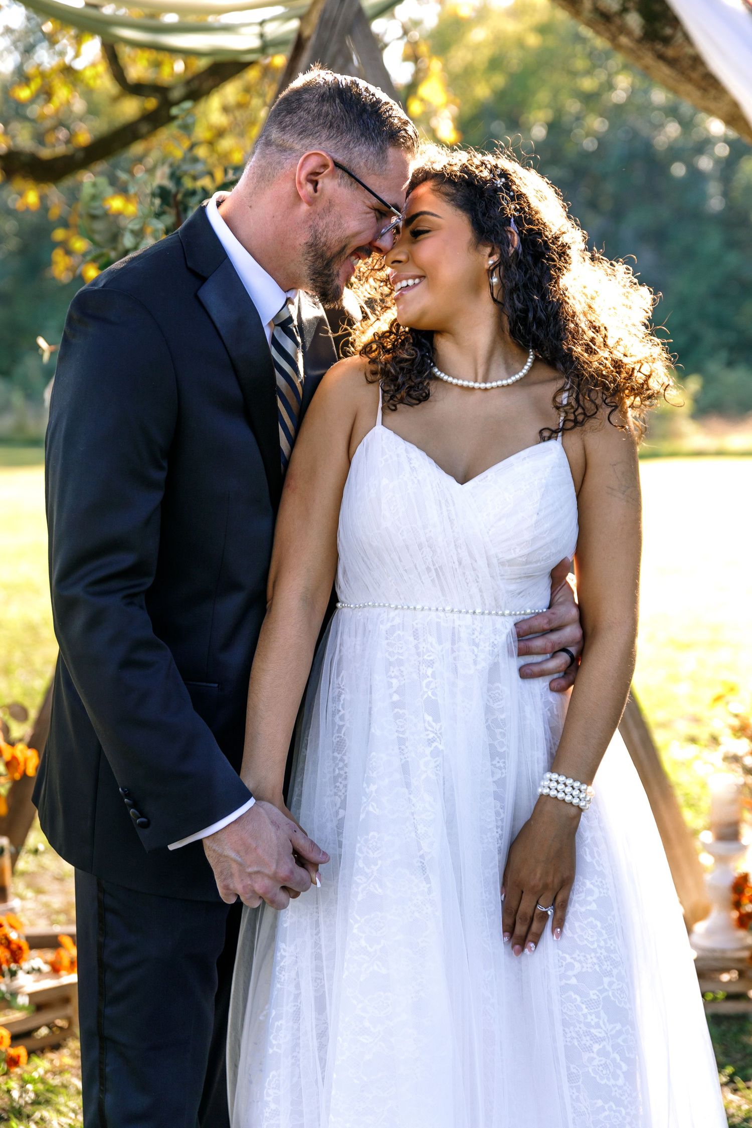 Romantic wedding couple portraits showing tender moments in golden afternoon light.