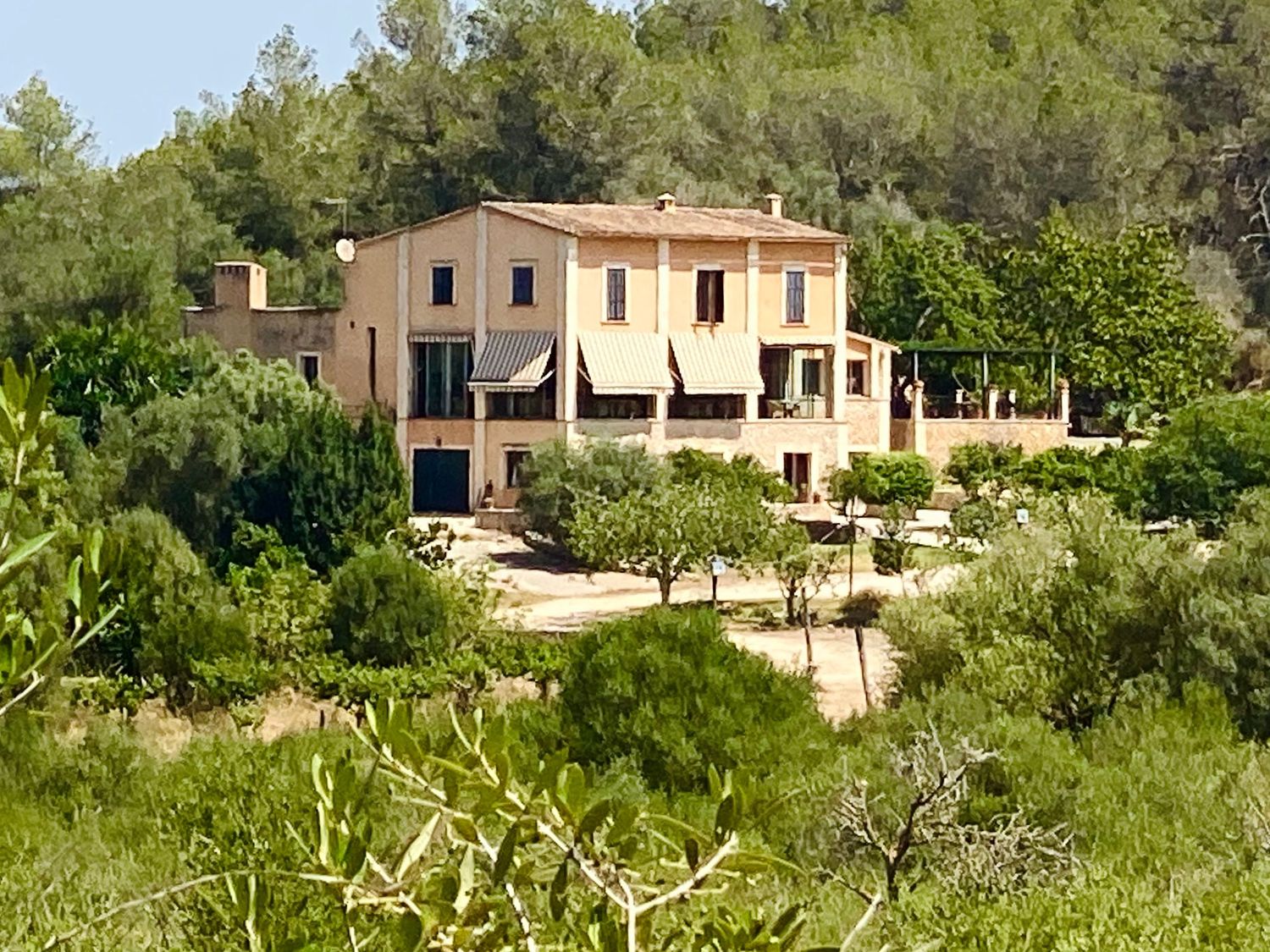 Luxury villa with infinity pool reflecting warm evening lights and contemporary architecture.