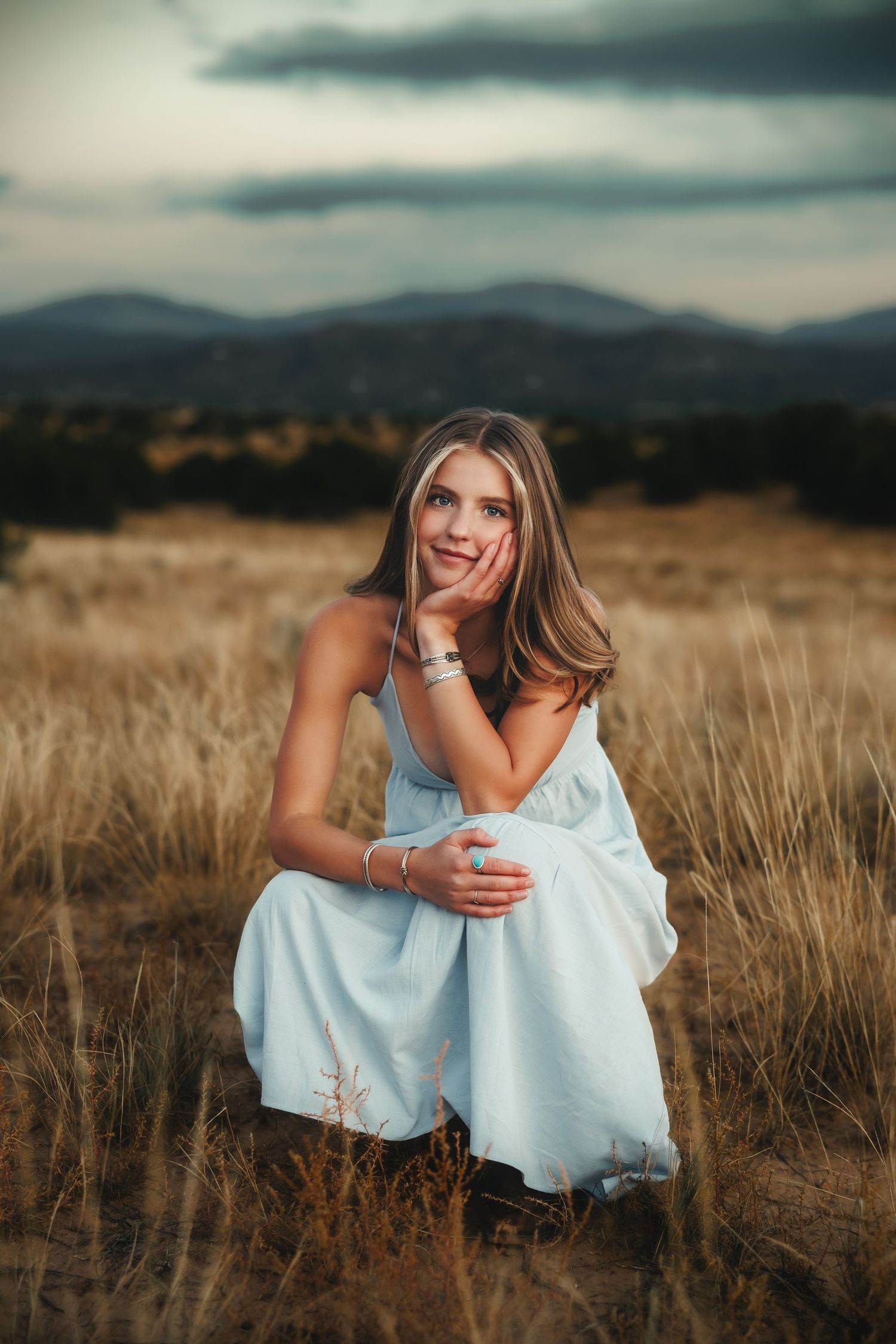 Santa Fe senior portrait with beautiful moody moutain backdrops and natural, organic golden light