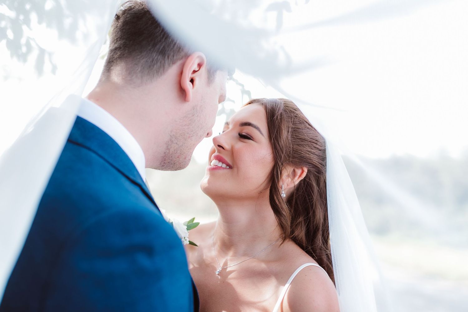 Intimate moment between newlyweds sharing joyful laughter outdoors. Photographer. Hull. East Yorkshire. Photography