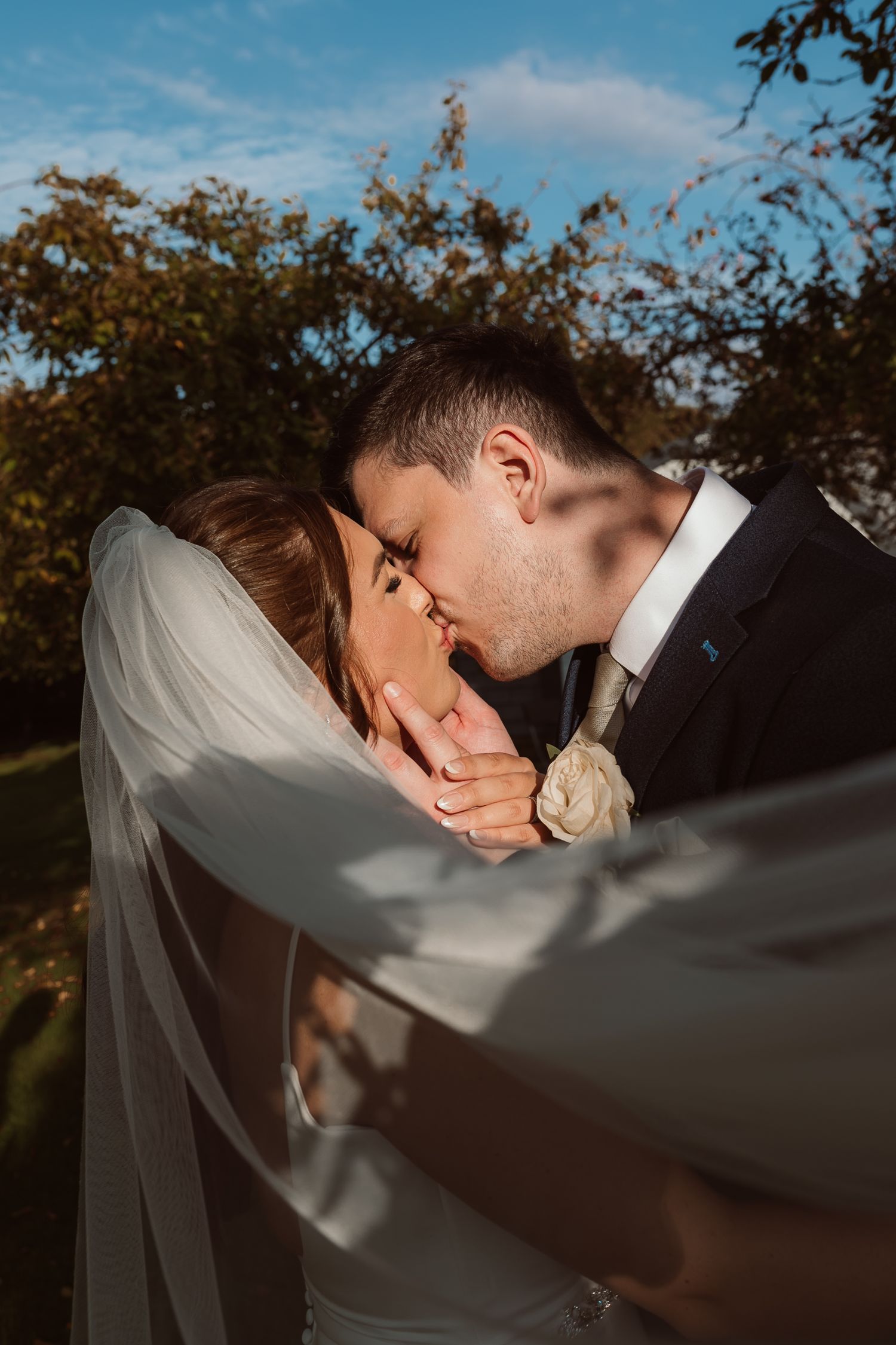 Intimate wedding portrait with flowing veil against autumn backdrop. Photographer. Hull. East Yorkshire. Photography