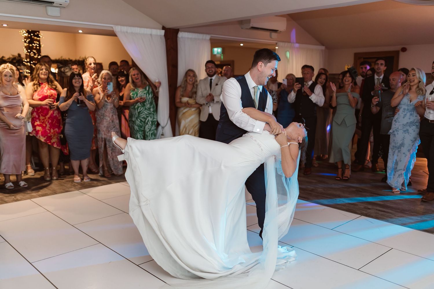 Wedding couple performs dramatic dance dip during reception celebration. Photographer. Hull. East Yorkshire. Photography