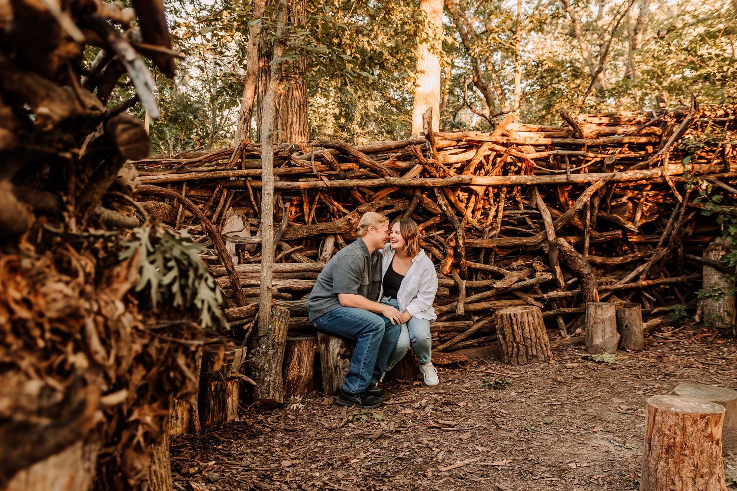 Engaged couple laughs together in woods during engagement session in Lacrosse, WI
