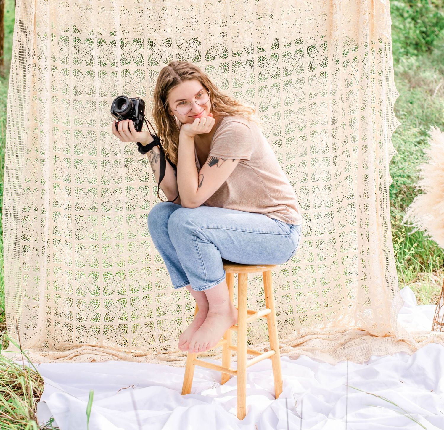 Lifestyle photography session features casual poses against decorative textile backdrop outdoors.