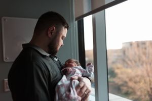 Family silhouettes against bright windows in a contemporary space.