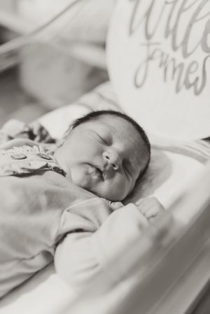 Black and white portrait of peaceful sleeping newborn baby.