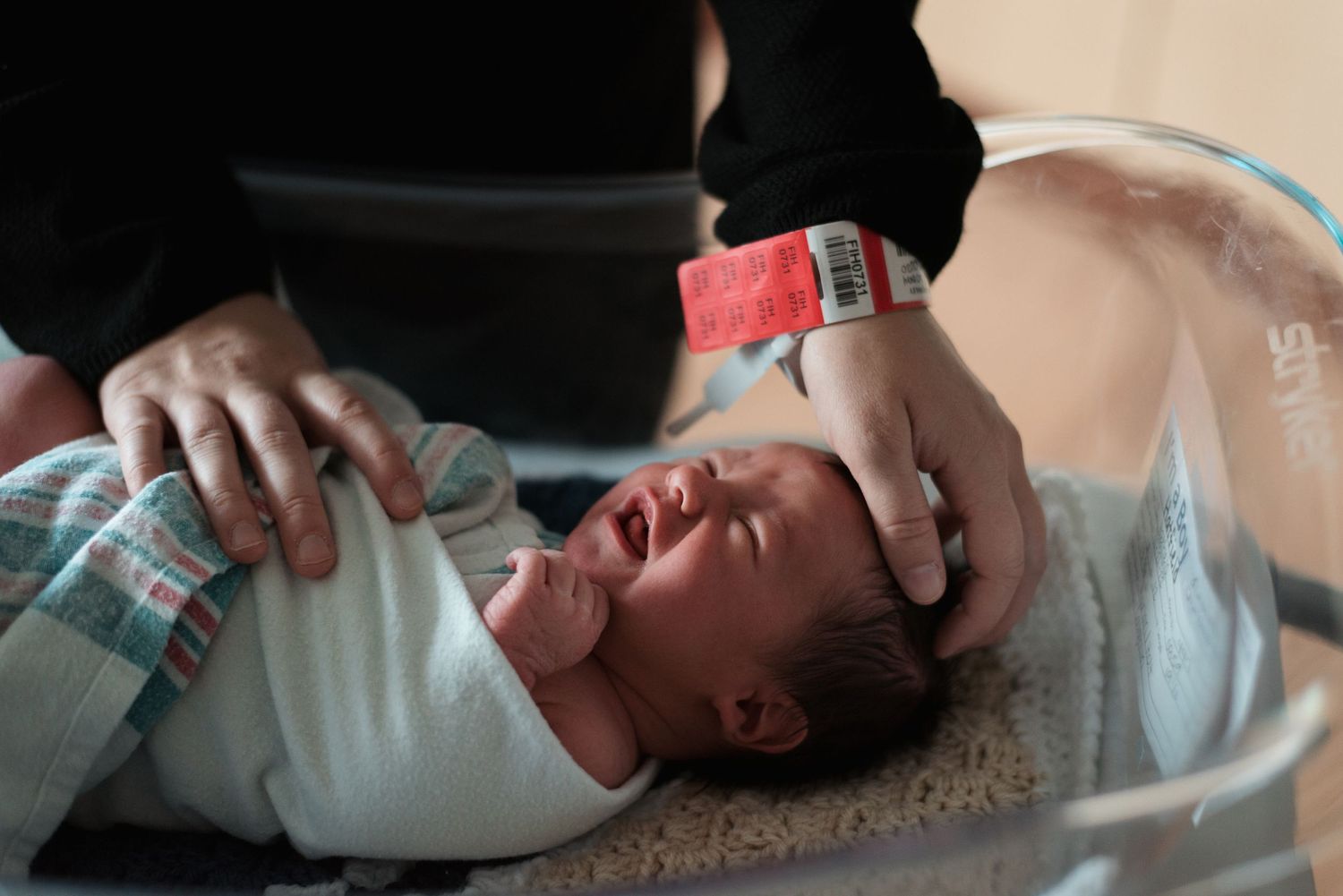 Newborn baby being bottle fed while lying down in a peaceful setting.