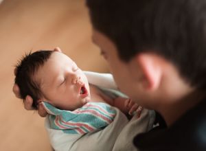 Tender moment of bottle feeding a newborn baby.